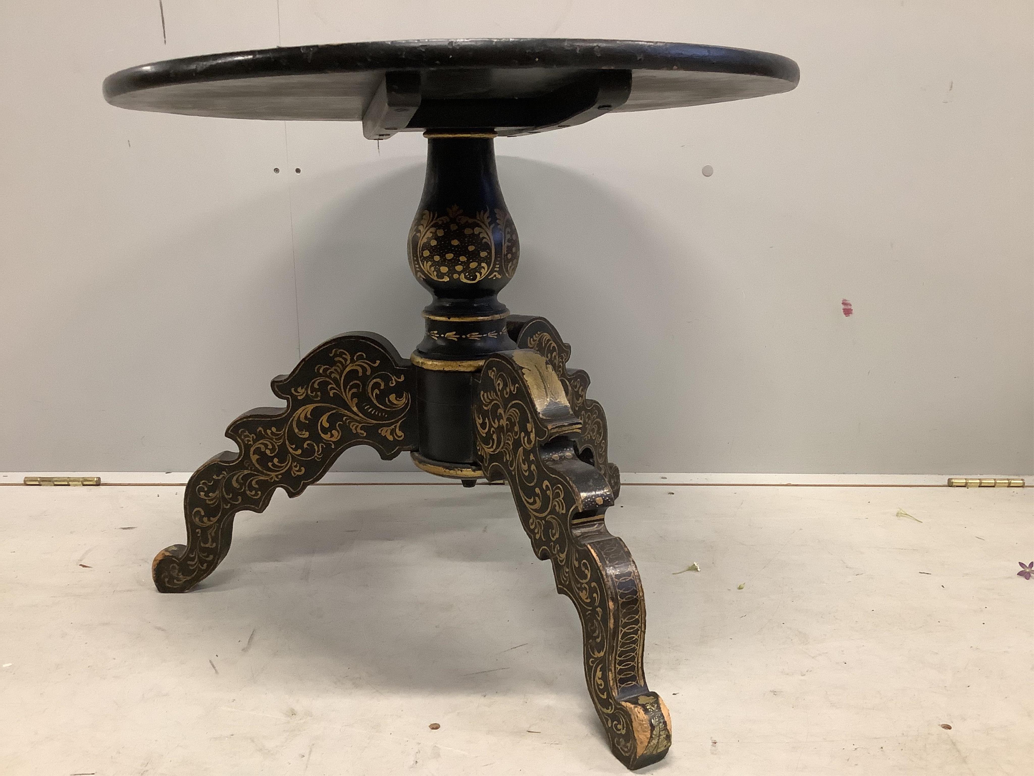 A 19th century chinoiserie lacquered circular tilt top tripod table, diameter 65cm, height 54cm, (reduced). Condition - poor